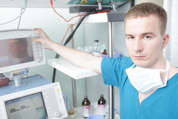 Young male doctor working with medical equipment.