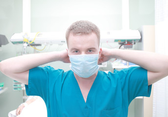 Young doctor man wears a surgical mask