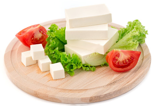 Sliced feta cheese with salad and tomato