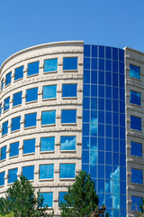 Fototapeta premium Curved Stone and Blue Glass Office Tower
