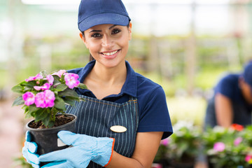 young female gardener holding flowers