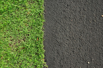 New asphalt road surface and green grass, background