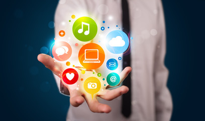 Young businessman presenting colorful technology icons and symbo