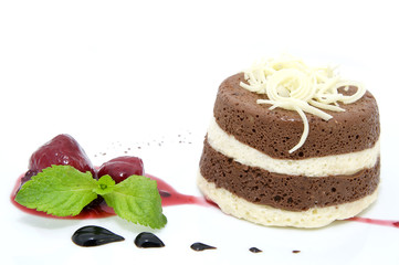 piece of cream cake decorated with chocolate and mint
