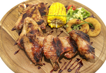 Grilled chicken wings on a wooden platter