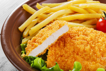 breaded chicken schnitzel fries - 64283736