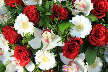Cymbidium orchids, red roses and white gerberas