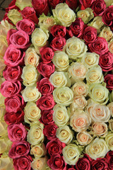 Pink roses in different shades in wedding arrangement