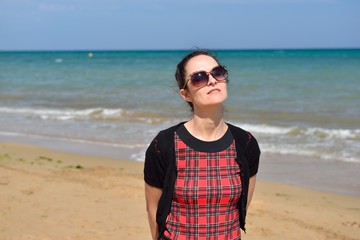 Young woman walking on the beach in the sand