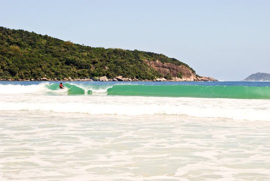 Surfer on Praia Lopes Mendes beach at Ilha Grande Island Brasil