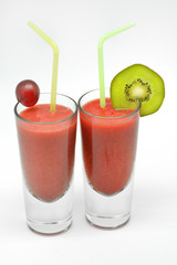 strawberry milkshake in two glasses isolated in white