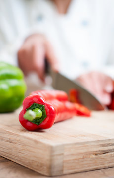 chef cutting red pepper