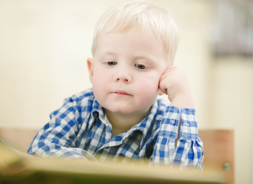 little boy listening story from book