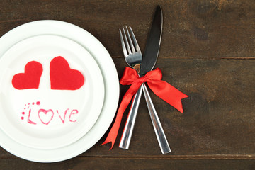 Romantic holiday table setting, on wooden background