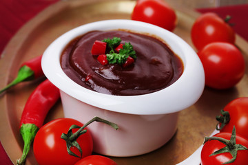 Tomato sauce in bowl on wooden table close-up