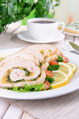 Delicious chicken roll on plate on table close-up