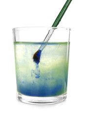 Brush with color paint in glass of water, isolated on white