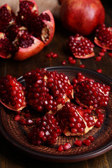 Ripe pomegranates on table close-up