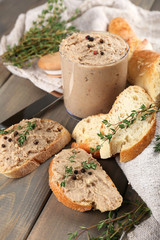 Fresh pate with bread on wooden table