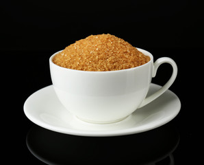 Sugar in cup isolated on black