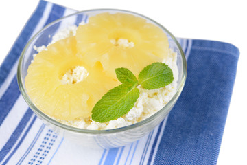 Bowl of tasty cottage cheese with pineapple, close up