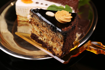 Assortment of pieces of cake, on dark background © Africa Studio