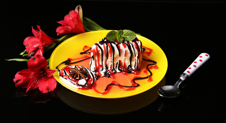 Tasty cake with cream, on black background © Africa Studio