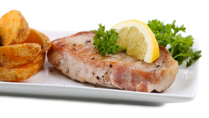 Grilled steak and fried potato pieces isolated on white