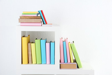 Books on white shelves in room