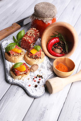 Composition of knife,  tasty sandwiches with salami sausage,