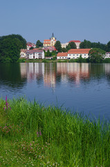 Fototapeta na wymiar Landscape with pond and church in the background, Czech Republic