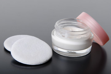 Jar of moisturizer cream and cotton