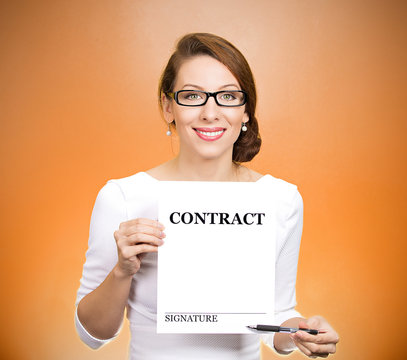 Portrait businesswoman holding document offering to sign here