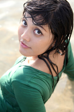 Sweet adorable asian woman in green wet t-shirt