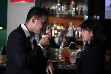 Photograph of couple relaxing at bar or lounge