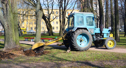 tractor roots out a stub in the gardens