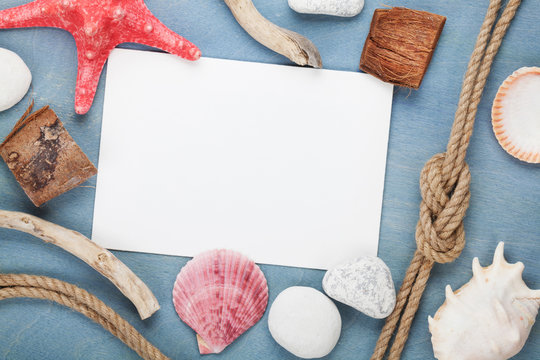 Blank paper card with seashells, ship rope, sea stones