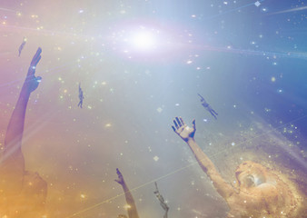 Obraz na płótnie Canvas People soaring toward light amongst stars