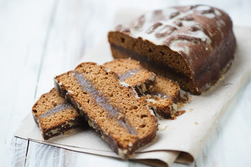 Sliced honey-cake on a packaging paper, horizontal shot