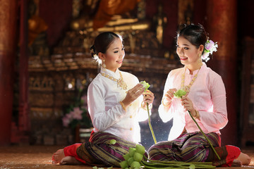 Thai girl making lotus flower in temple