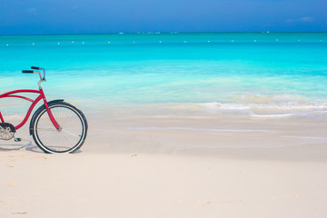 Bike on a tropical beach against the turquoise ocean and blue