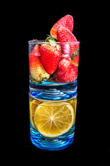 oranges and strawberries on a glass