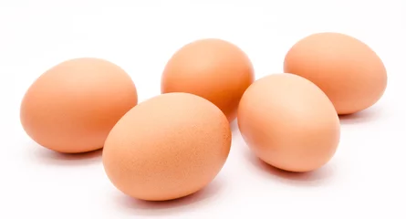 Fotobehang Five brown chicken eggs isolated on a white background © svetamart