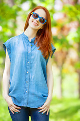 Redhead girl in the park in spring time.