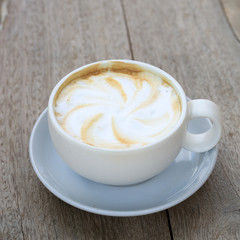 Cappuccino coffee cup on wooden background