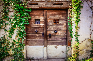 Old wooden textured door and weathered wall