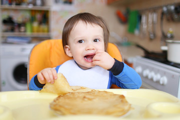 baby eats pancakes