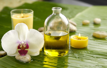 Health spa with massage oil and orchid ,candle on leaf