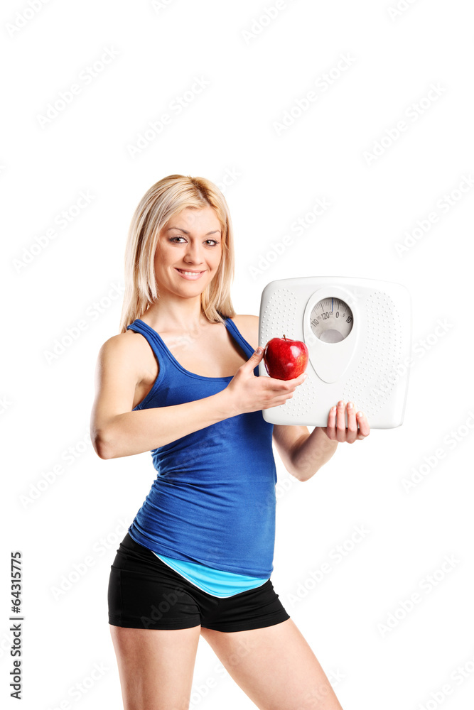 Wall mural Woman holding an apple and a weight scale