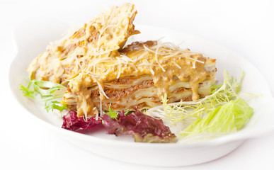 lasagna with yellow sauce and parmesan